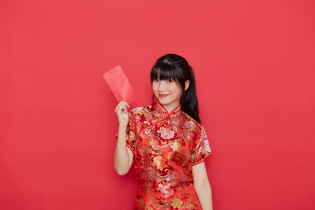 Cute Chinese woman holding red envelope