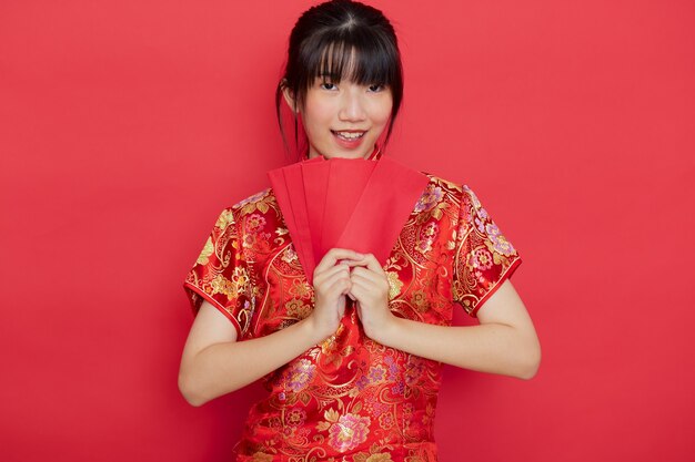 Cute Chinese woman holding red envelopes