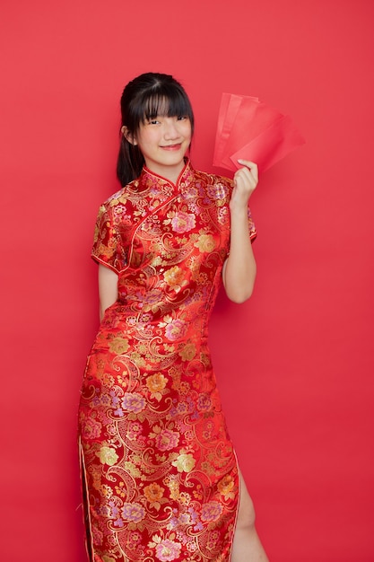 Cute Chinese woman holding red envelopes