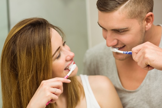 Cute couple brushing their teeth