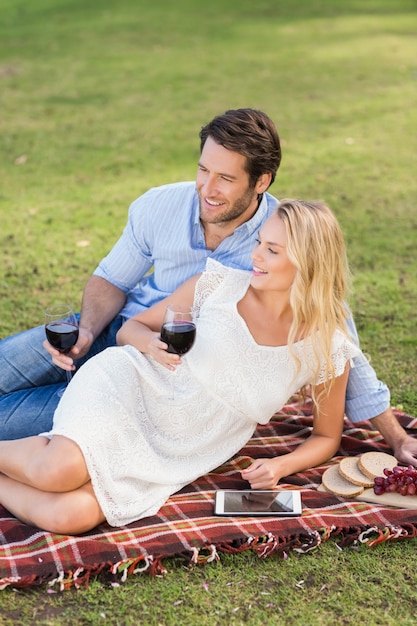 Cute couple on date holding red wine glasses