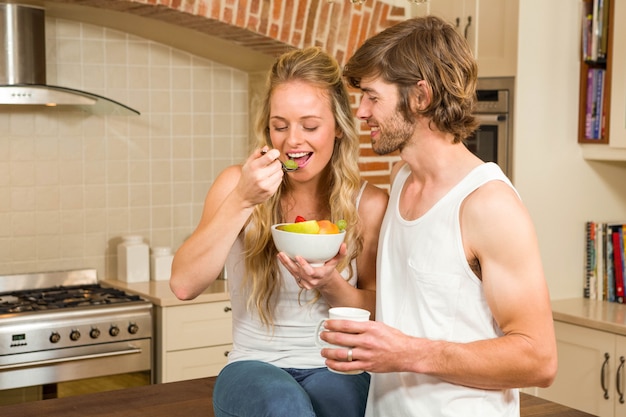 Cute couple having breakfast in the kitchen