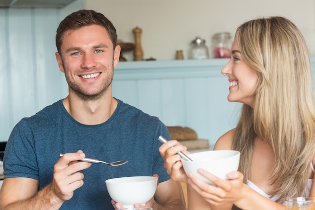 Cute couple having cereal for breakfast