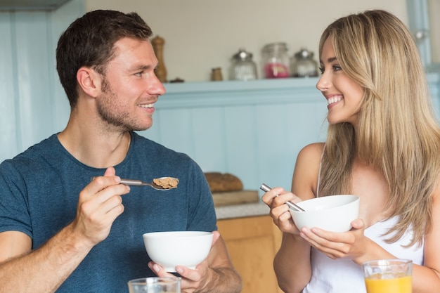 cute couple having cereal for breakfast