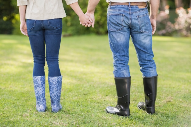 Cute couple holding hands in the garden