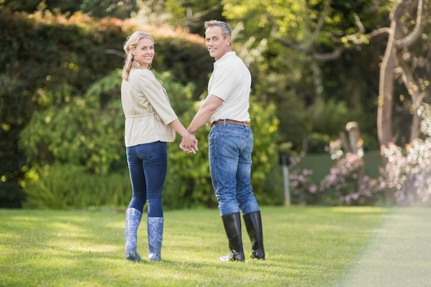 Cute couple holding hands in the garden