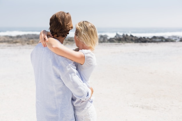 Cute couple hugging on the beach