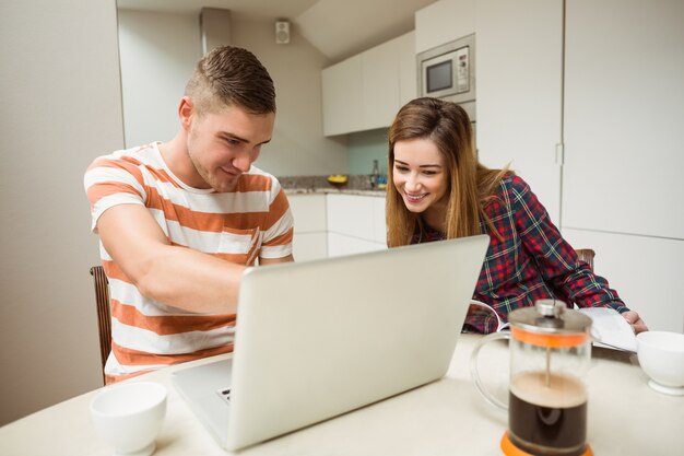 Cute couple looking at laptop