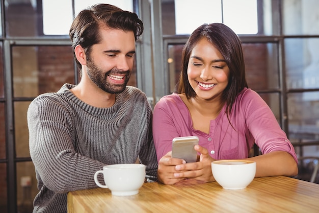 Cute couple looking at a smartphone