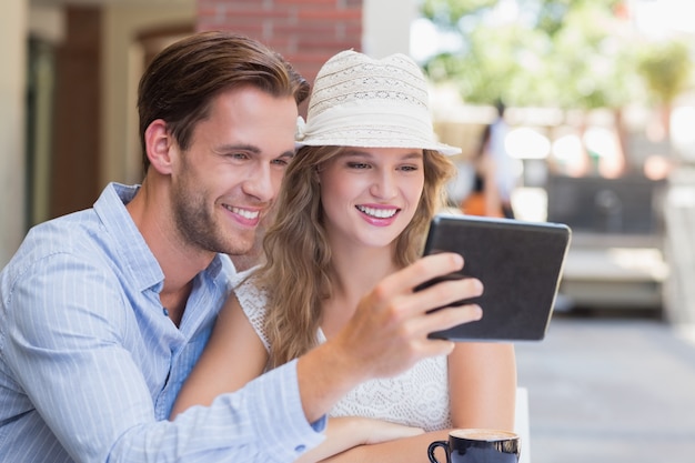 Cute couple looking at a tablet