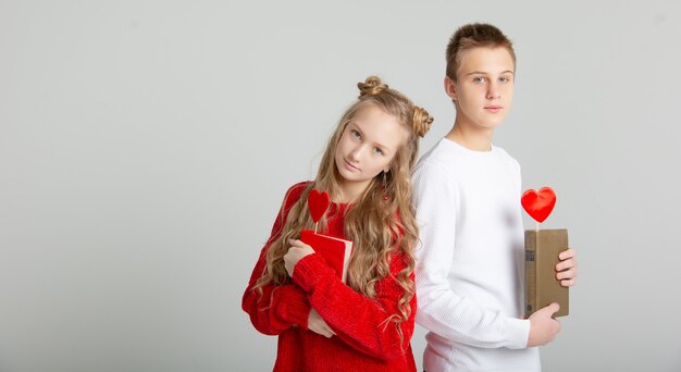 Cute couple in love with schoolchildren on Valentine's Day