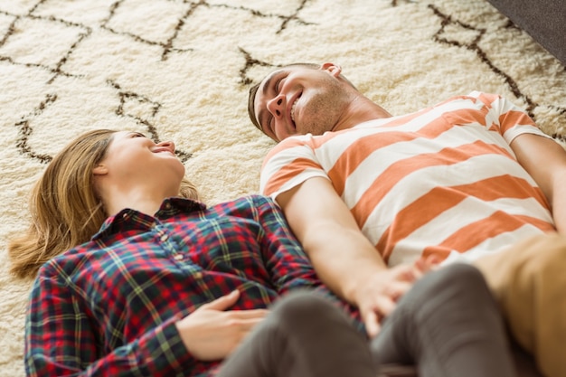 Photo cute couple lying on floor