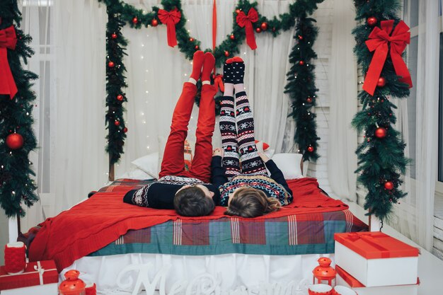 Cute couple outfitted with a christmas tree