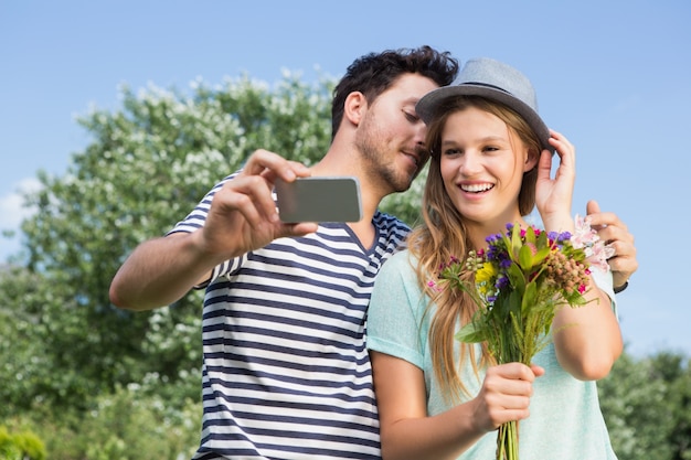 Cute couple in the park taking selfie