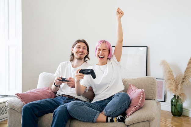 Cute couple playing together a video game at home