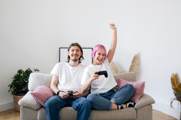 Cute couple playing together a video game at home