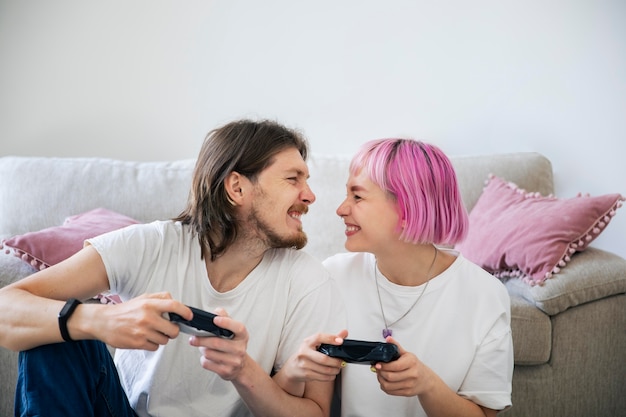 Cute couple playing together a video game at home