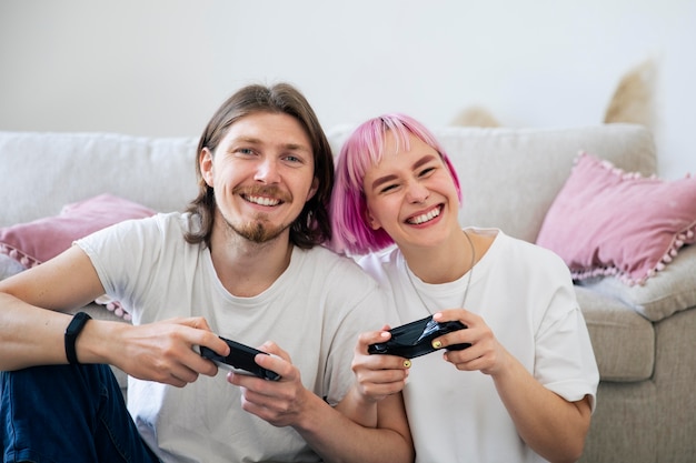 Cute couple playing together a video game at home