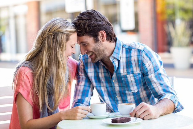  Cute couple sitting at a cafe head to head