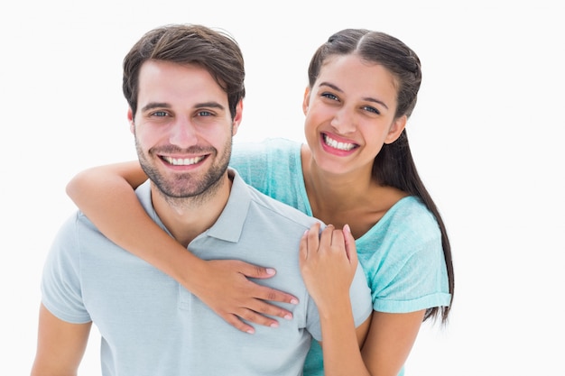 Cute couple smiling at camera on white background