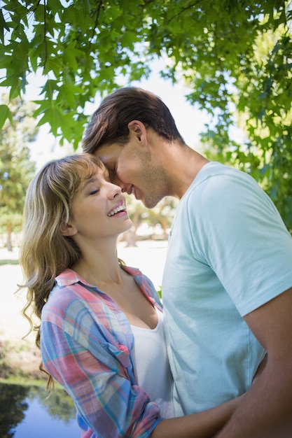 Cute couple smiling and hugging in the park