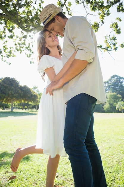 Cute couple standing in the park embracing