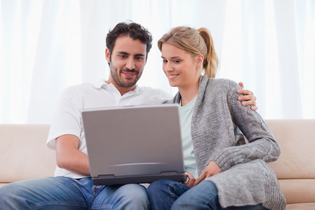 Cute couple using a notebook