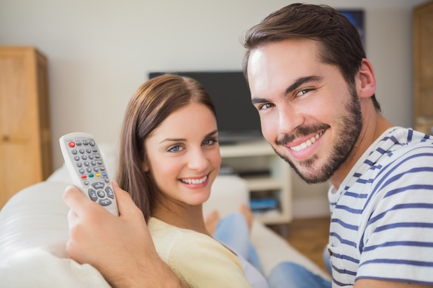 Cute couple watching tv on the couch