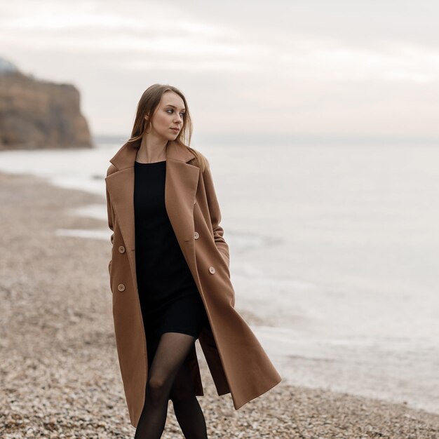 cute cozy smiling woman outdoor near the sea