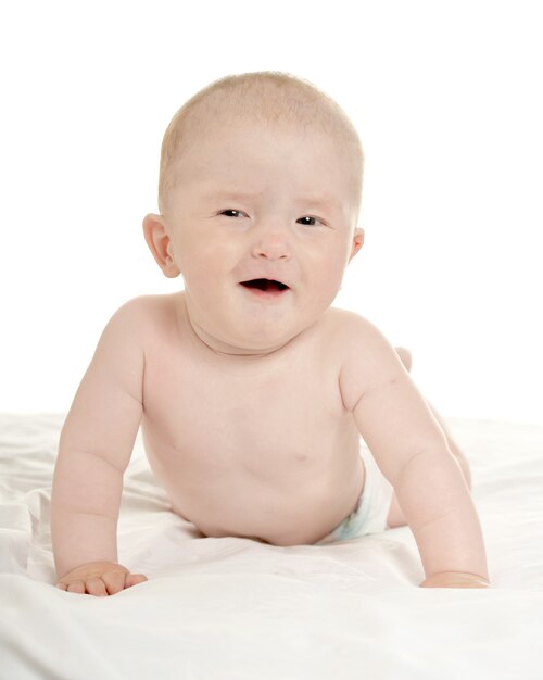 Cute crawling baby boy isolated on white background