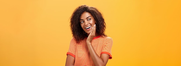 Cute creative and feminine stylish african american young female in striped tshirt leaning head on