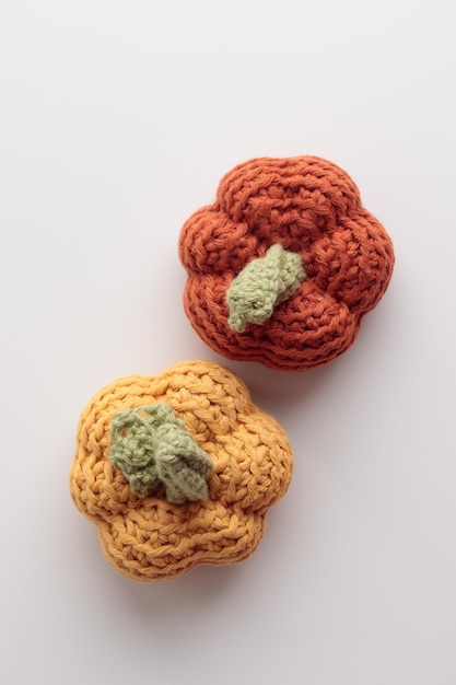 Cute crochet knitted pumpkins on gray background