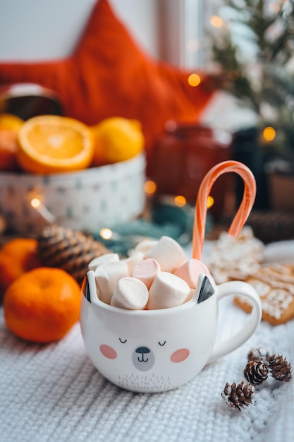 Cute cup of cocoa with marshmallows and christmas candy in new year atmosphere aesthetic photo