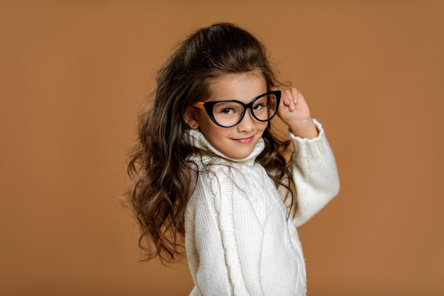Cute curly little child girl in glasses