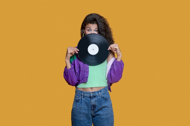 Cute dark-haired young woman holding a record