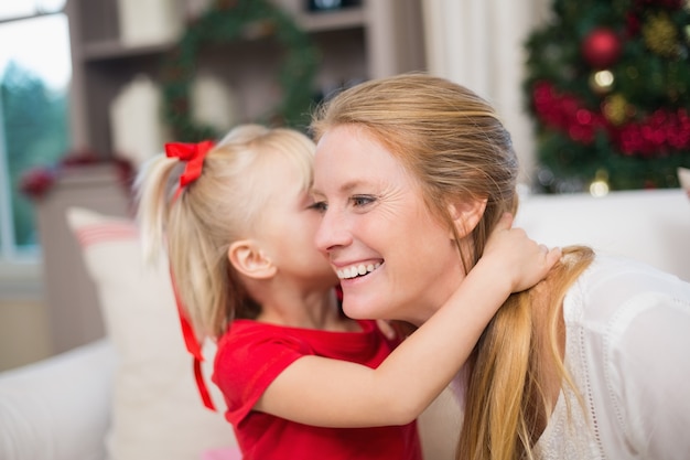 Cute daughter and mother celebrating christmas