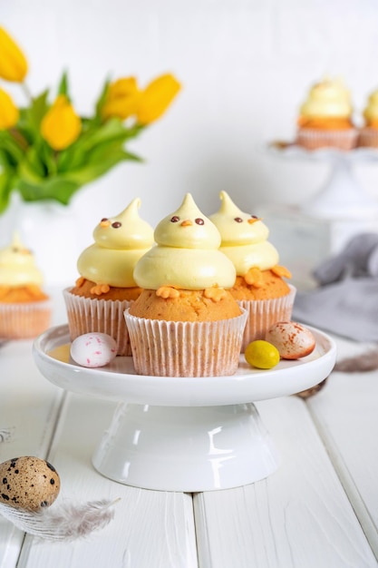 Cute Easter chick cupcakes Vanilla cupcakes with buttercream with fresh flowers Copy space