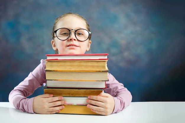 Cute Elementary Schoolgirl with a lot of books