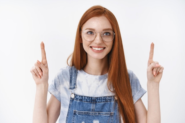 青い目をしたかわいい熱狂的な赤毛の女子学生そばかす喜びに満ちた笑顔上向き観察興味深いプロモーションを観察し、興味と喜びを表現する良い購入スタンド白背景