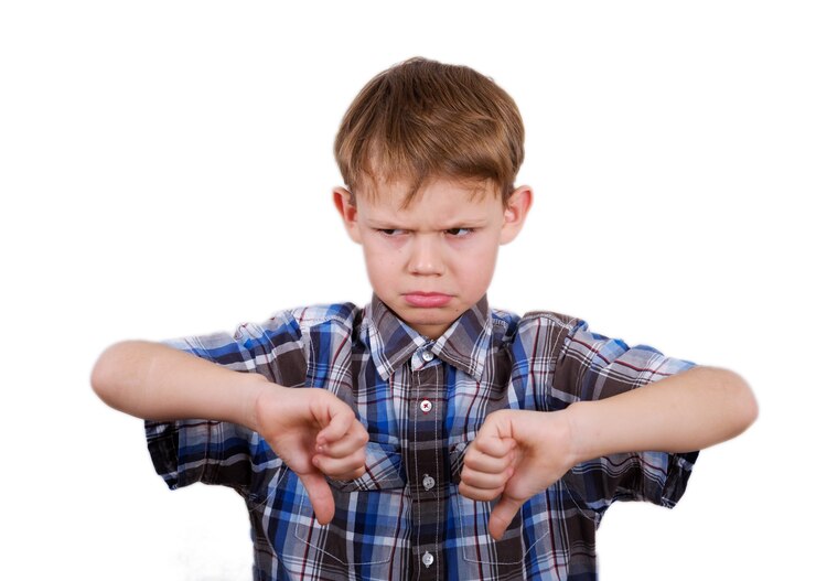 Cute European boy with a gesture dislike and expressed emotion of discontent on his face. isolate on white background