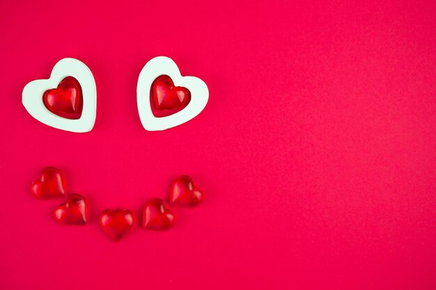 Cute face made of hearts on a red