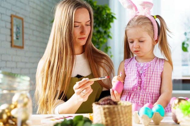 Cute family, mother and daughter preparing for Easter celebration