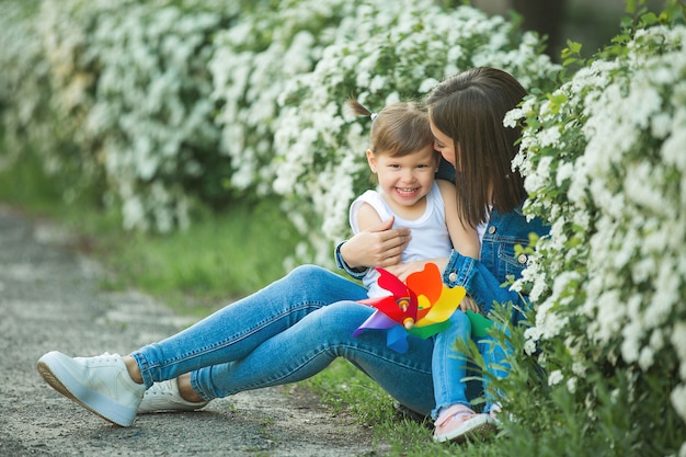 Cute family outdoors. Young pretty mother with her little daughter 