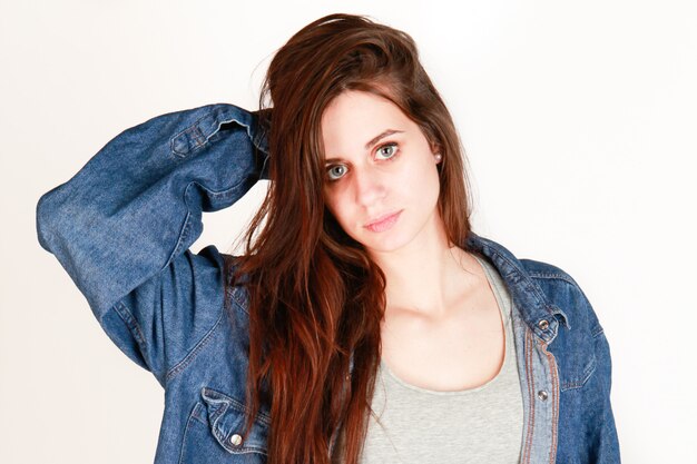 Cute fashion girl with long hairs in white wall