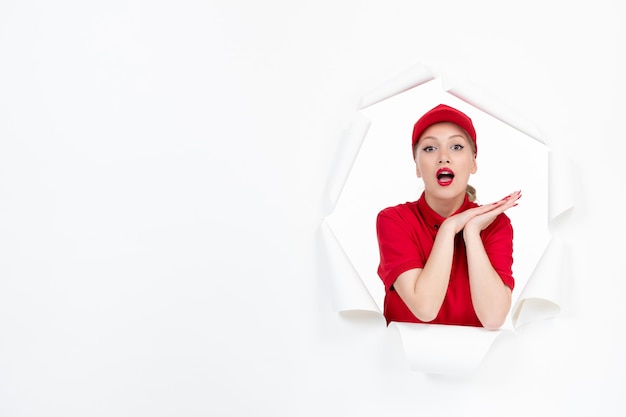 Cute female worker in red uniform on white