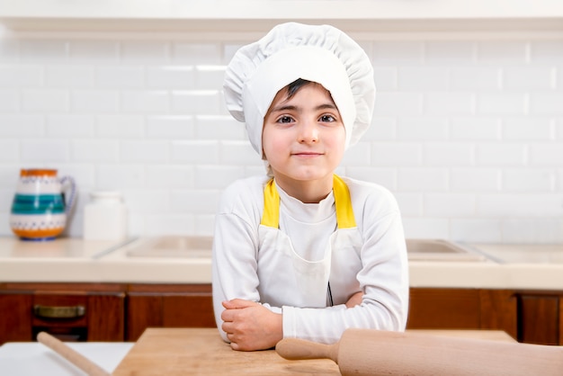 Cute five year old boy in chef attitude