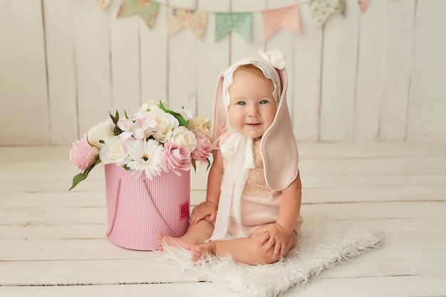 Cute funny baby with bunny ear costume posing