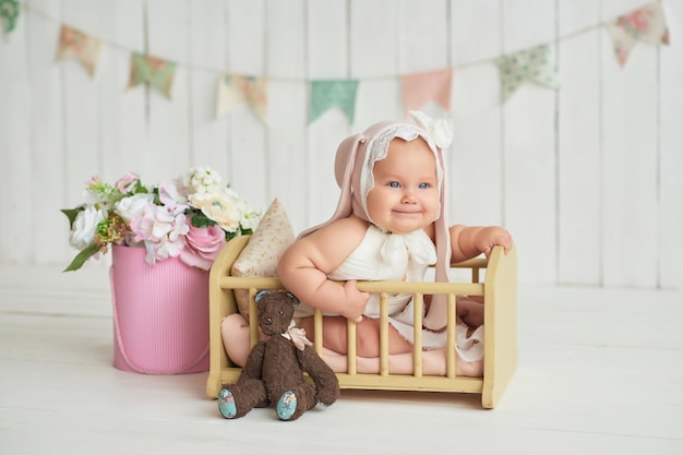 Cute funny baby with bunny ear. Cute baby girl 6 months in bed