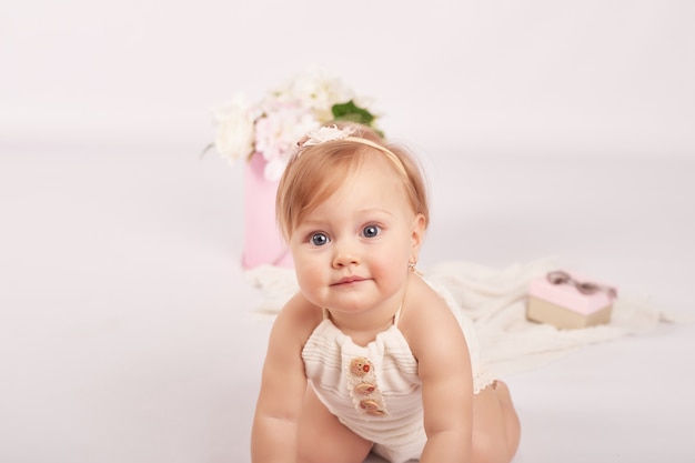 Cute funny baby with flowers. Cute baby girl.