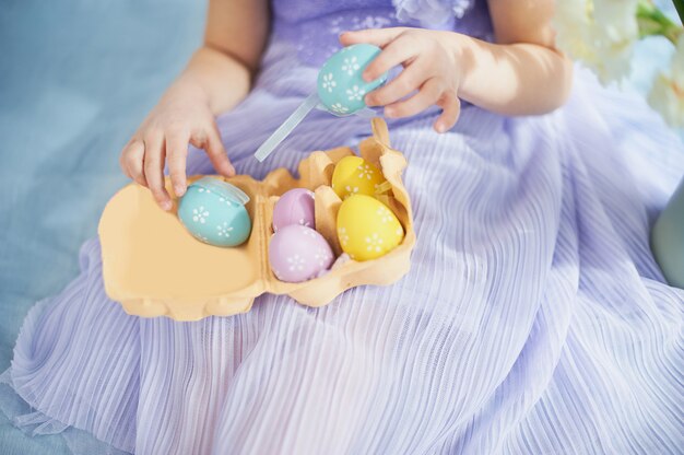 Cute funny girl with Easter eggs at home